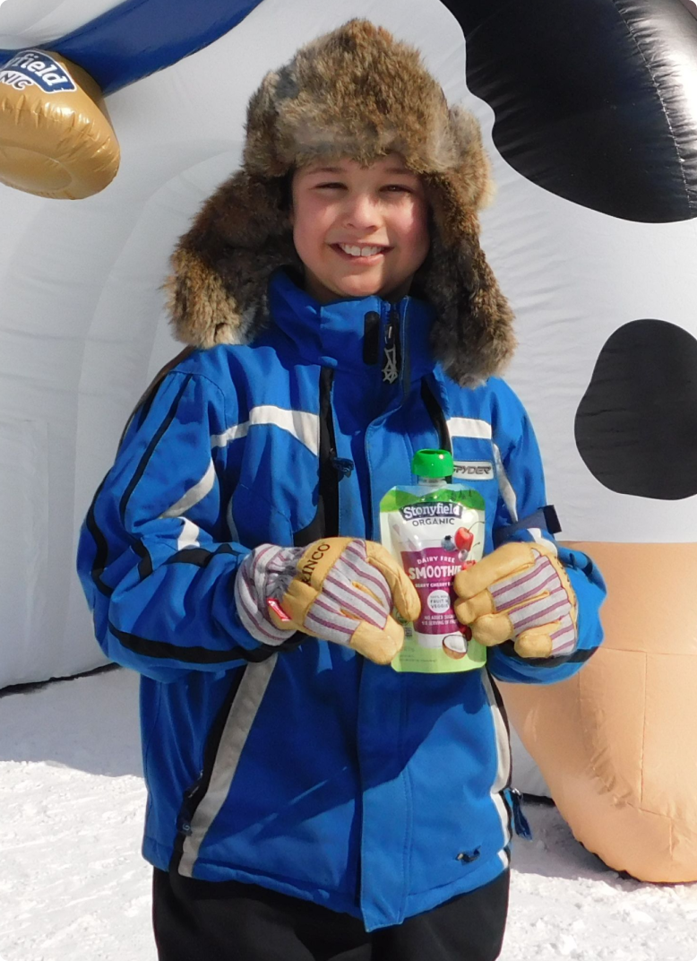 kid holding a Stonyfield smoothie
